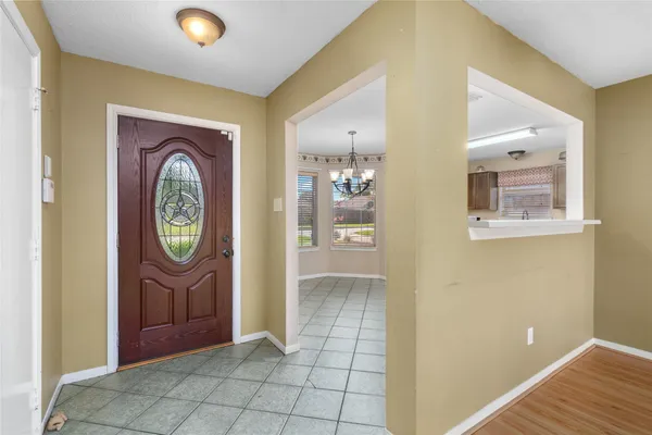 a view of an entryway with a table and a mirror