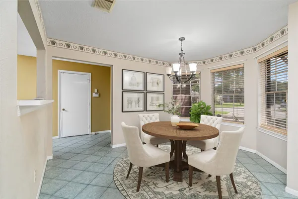 a dining room with furniture a chandelier and wooden floor