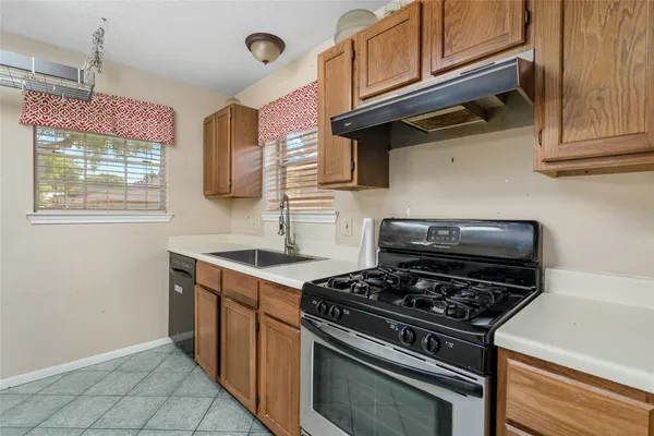 a kitchen with stainless steel appliances granite countertop a stove and a microwave