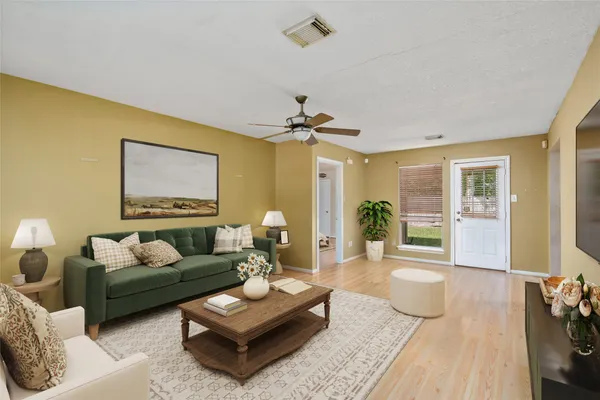 a living room with furniture and a chandelier