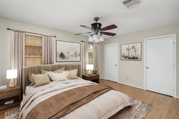 a bedroom with a large bed and a chandelier