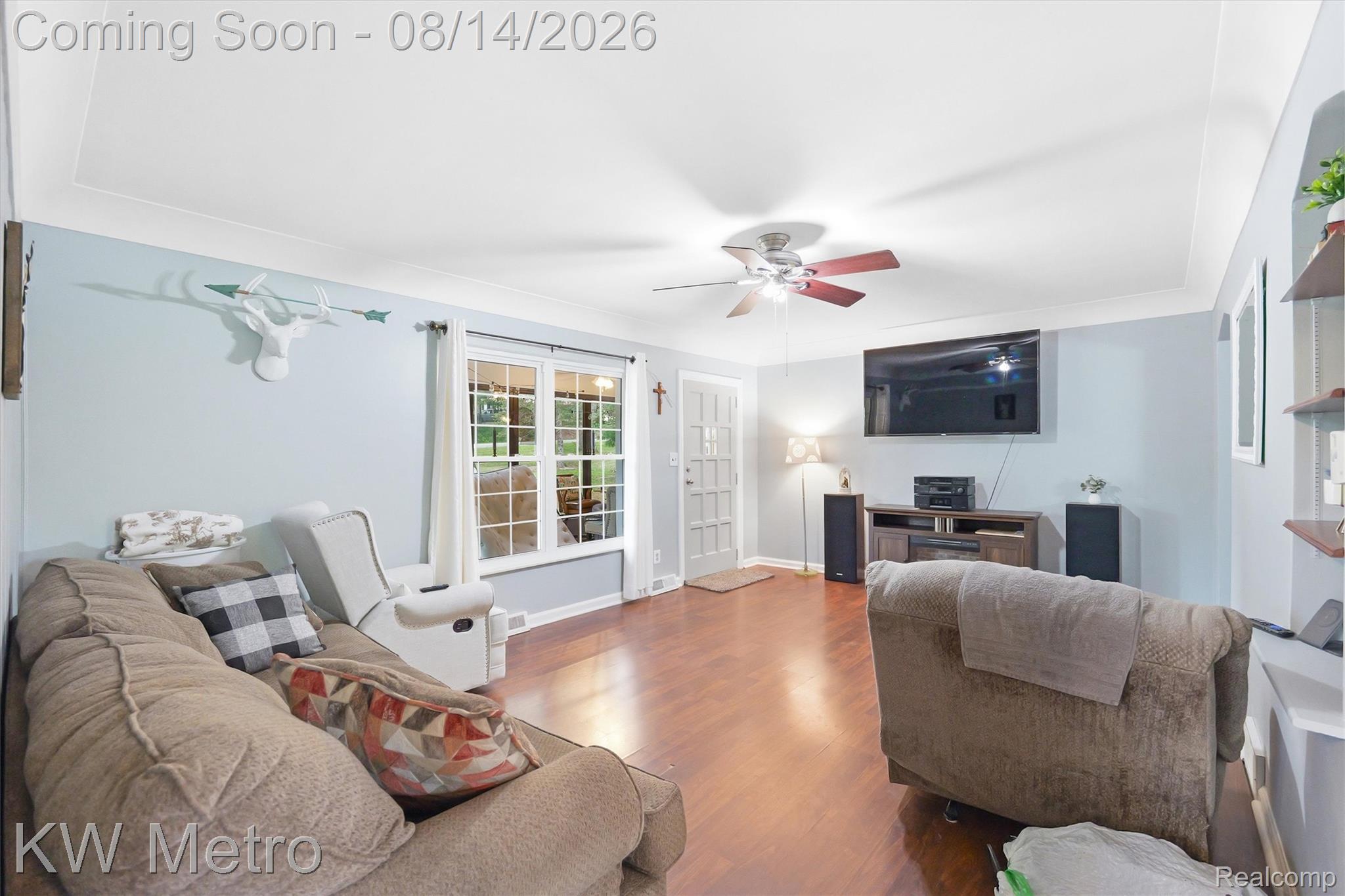 201 South Maple Leaf Road Lapeer, MI 48446 - Photo 18 of 70 Wood-finish flooring, white trim, tray ceiling, and a ceiling fan with integrated lighting