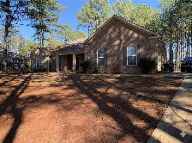 a backyard of a house with yard and outdoor seating