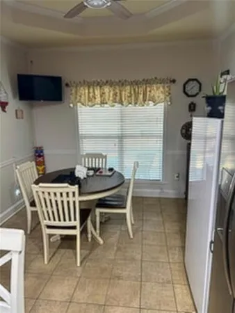a dining room with furniture and a window
