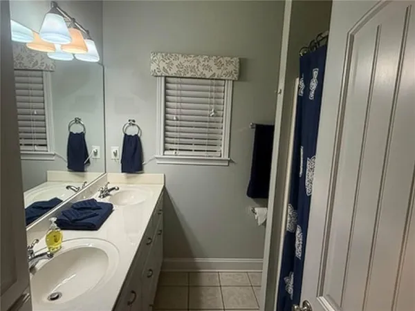 a bathroom with sink double vanity granite and shower