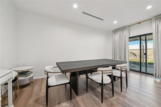 a view of a room with furniture and wooden floor