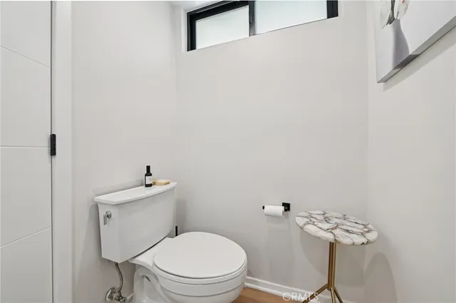 a white toilet sitting next to a white sink