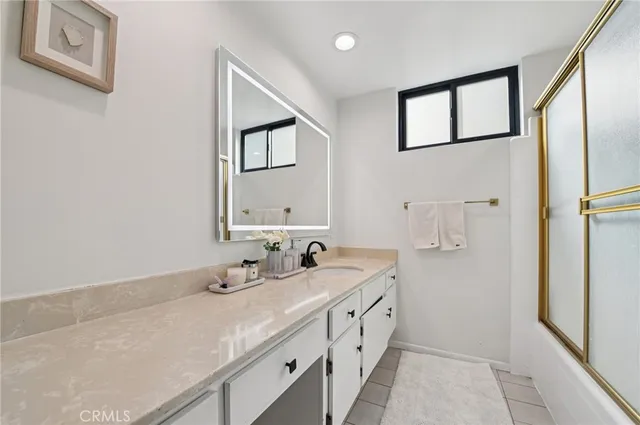 a bathroom with double vanity sink and a mirror