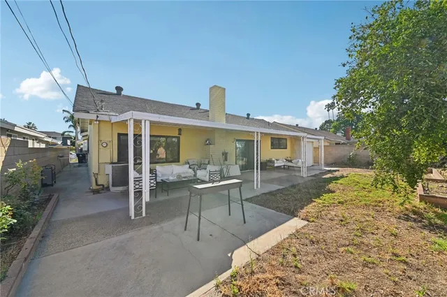 a view of a house with backyard porch and sitting area