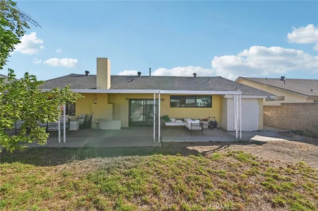 a backyard of a house with yard and outdoor seating