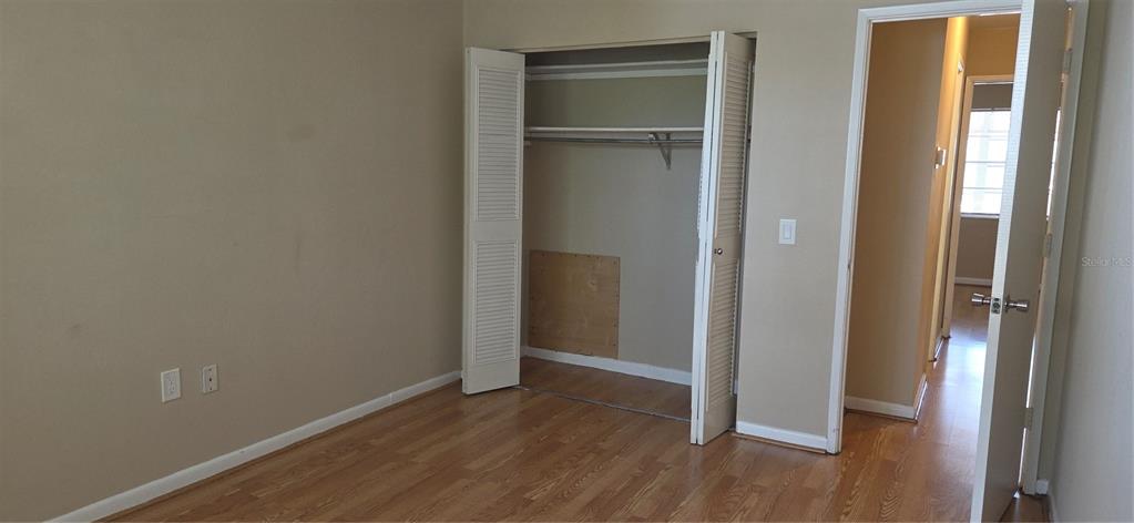 911 Washington Avenue Southwest, Unit 304 Largo, FL 33770 - Photo 17 of 26 a view of an empty room with wooden floor and closet