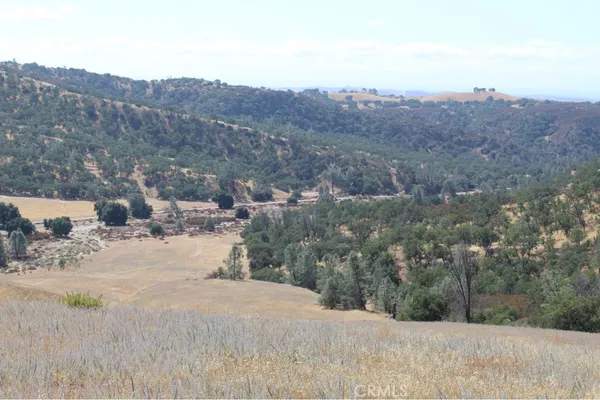 a view of a dry yard with mountains