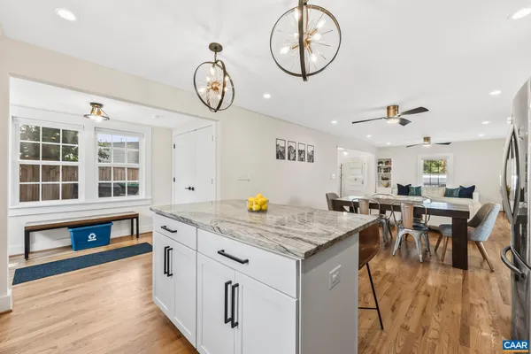 a very nice looking room with kitchen island furniture and a table