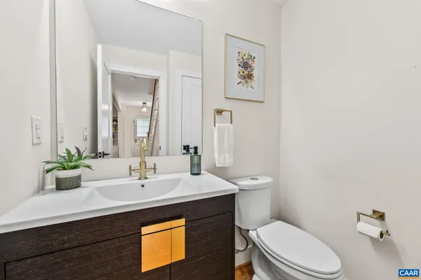 a bathroom with a sink mirror and toilet