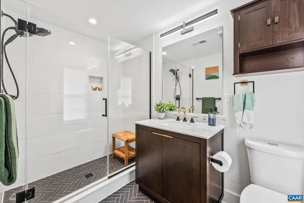 a bathroom with a sink toilet vanity and tub