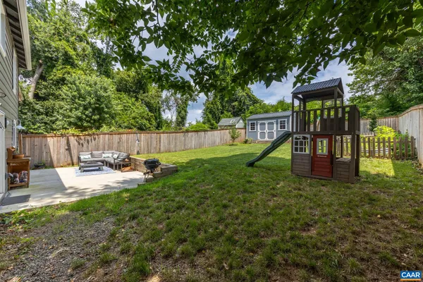 a view of a house with backyard and sitting area