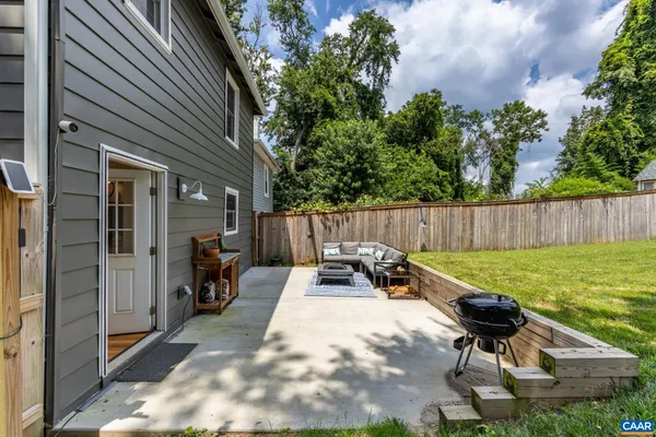 a backyard of a house with table and chairs