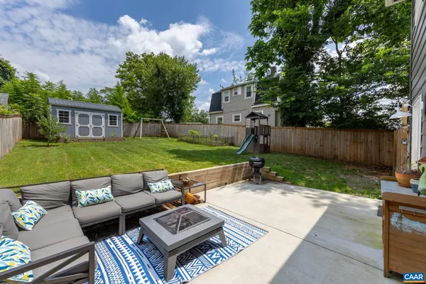 a view of backyard of house with seating space