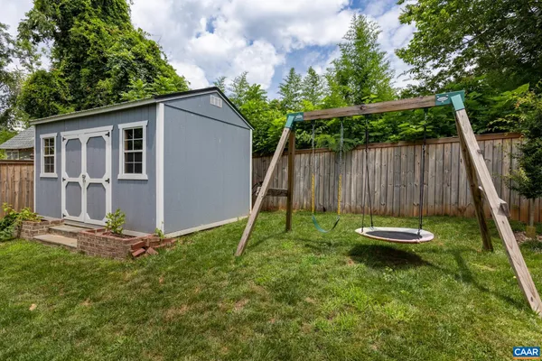 a backyard of a house with table and chairs
