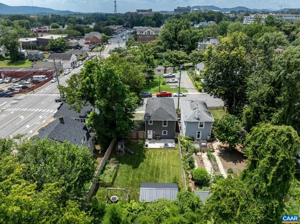an aerial view of a house with a yard and lake view