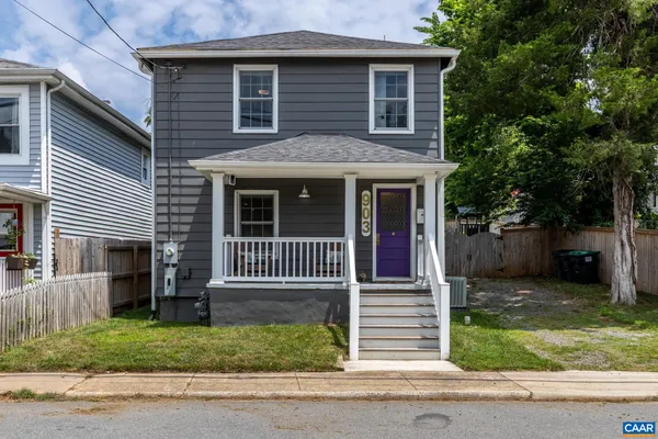 a front view of a house with a garden and plants