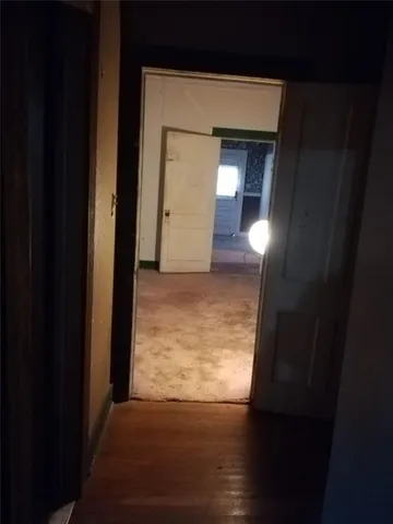 a view of hallway with wooden floor