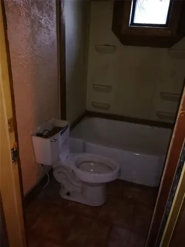 a bathroom with a toilet and a sink