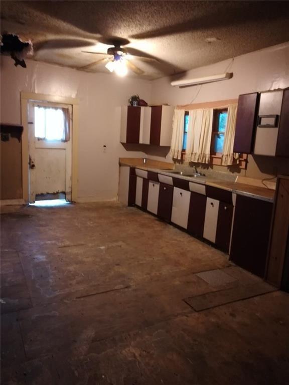 457 West Main Street Ranger, TX 76470 - Photo 6 of 7 a large kitchen with stainless steel appliances kitchen island granite countertop a sink and cabinets