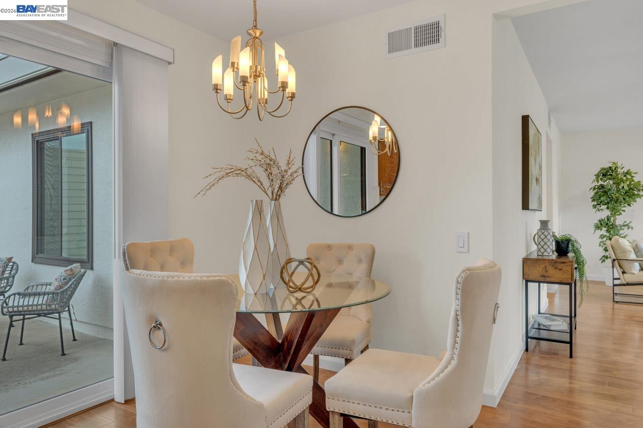 4034 Rennellwood Way Pleasanton, CA 94566 - Photo 22 of 42 a view of a dining room with furniture and wooden floor