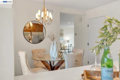 a bedroom with a bed and a view of kitchen