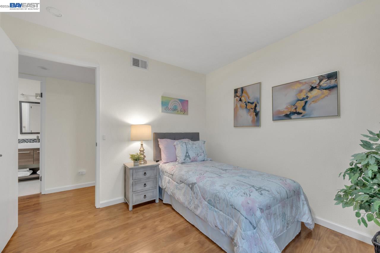 4034 Rennellwood Way Pleasanton, CA 94566 - Photo 28 of 42 a bedroom with a bed and a view of kitchen