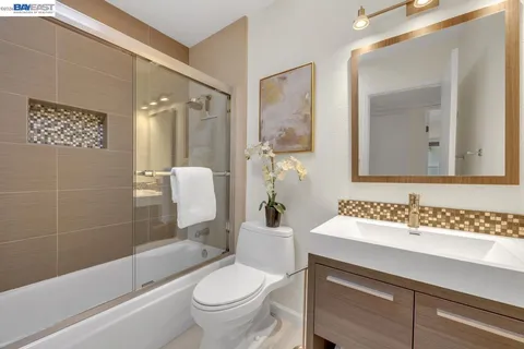 a bedroom with bed and paintings on the wall