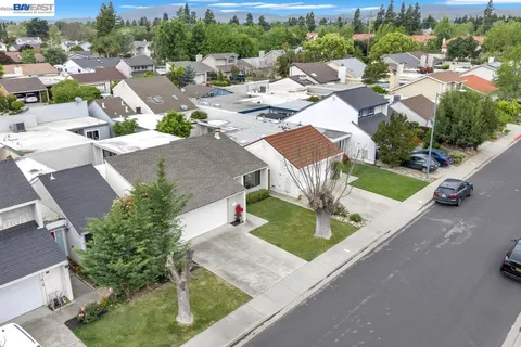 an aerial view of a house with garden space and street view