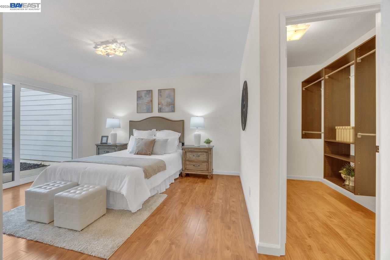 4034 Rennellwood Way Pleasanton, CA 94566 - Photo 32 of 42 a bedroom with a bed and a chandelier