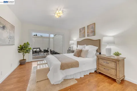 a bedroom with a bed and a lamp on dresser