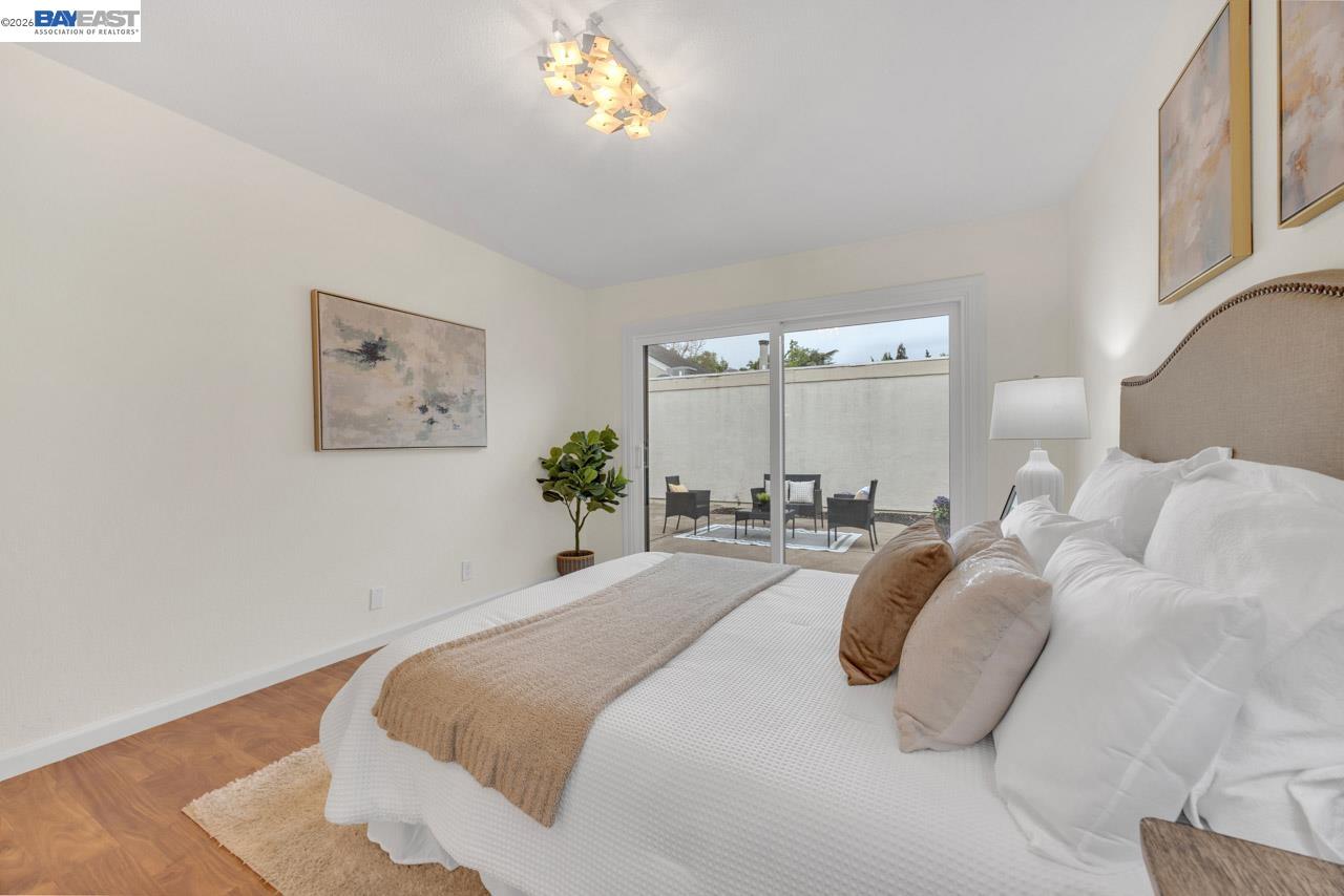 4034 Rennellwood Way Pleasanton, CA 94566 - Photo 34 of 42 a bedroom with a bed and a chandelier