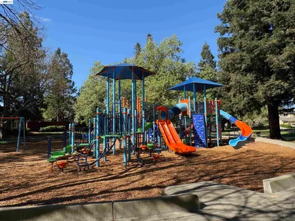 a view of a park with swings and slides
