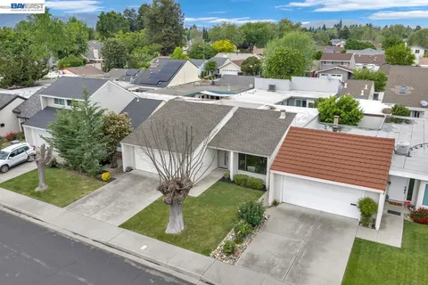 an aerial view of a house with garden space and street view