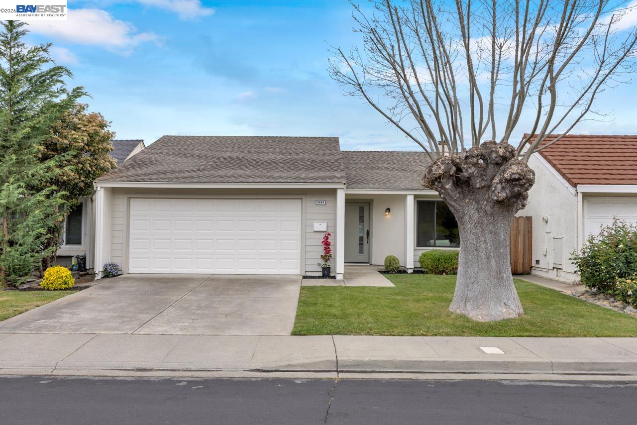 4034 Rennellwood Way Pleasanton, CA 94566 - Photo 5 of 42 a front view of a house with a yard garage and outdoor seating