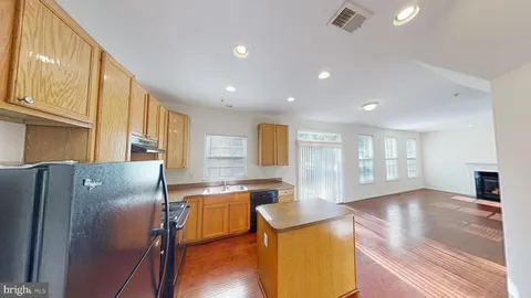 an empty room with wooden floor and closet