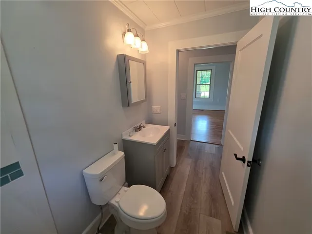 a white toilet sitting next to a sink