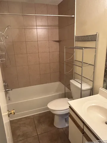 a bathroom with a toilet a sink and shower