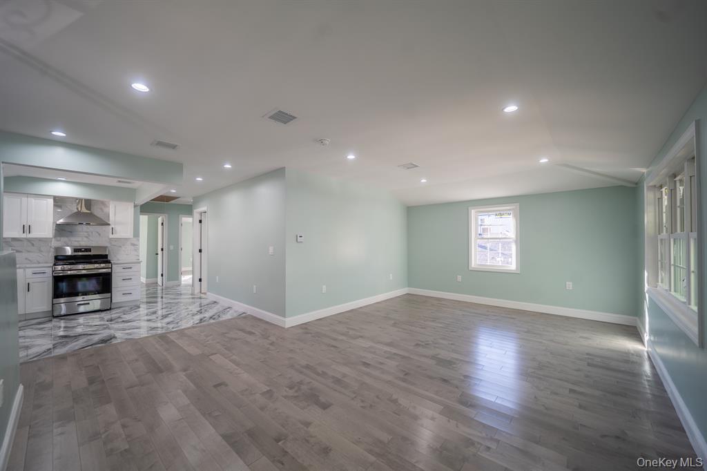 115-42 Inwood Street, Unit 2 Queens, NY 11436 - Photo 11 of 14 a view of a kitchen with a sink oven cabinets and a window