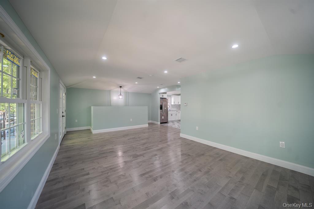 115-42 Inwood Street, Unit 2 Queens, NY 11436 - Photo 12 of 14 a view of a big room with windows and chandelier fan