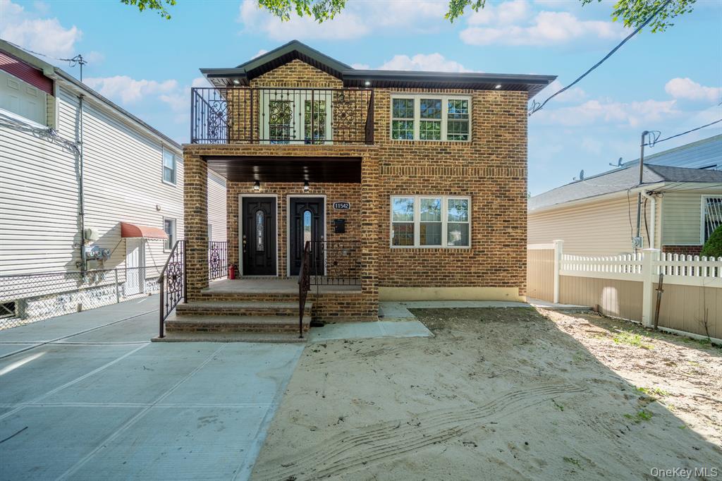 115-42 Inwood Street, Unit 2 Queens, NY 11436 - Photo 2 of 14 a front view of a house with a porch