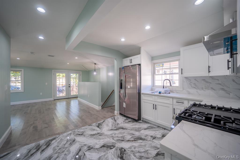115-42 Inwood Street, Unit 2 Queens, NY 11436 - Photo 9 of 14 a kitchen with stainless steel appliances granite countertop a sink stove and refrigerator