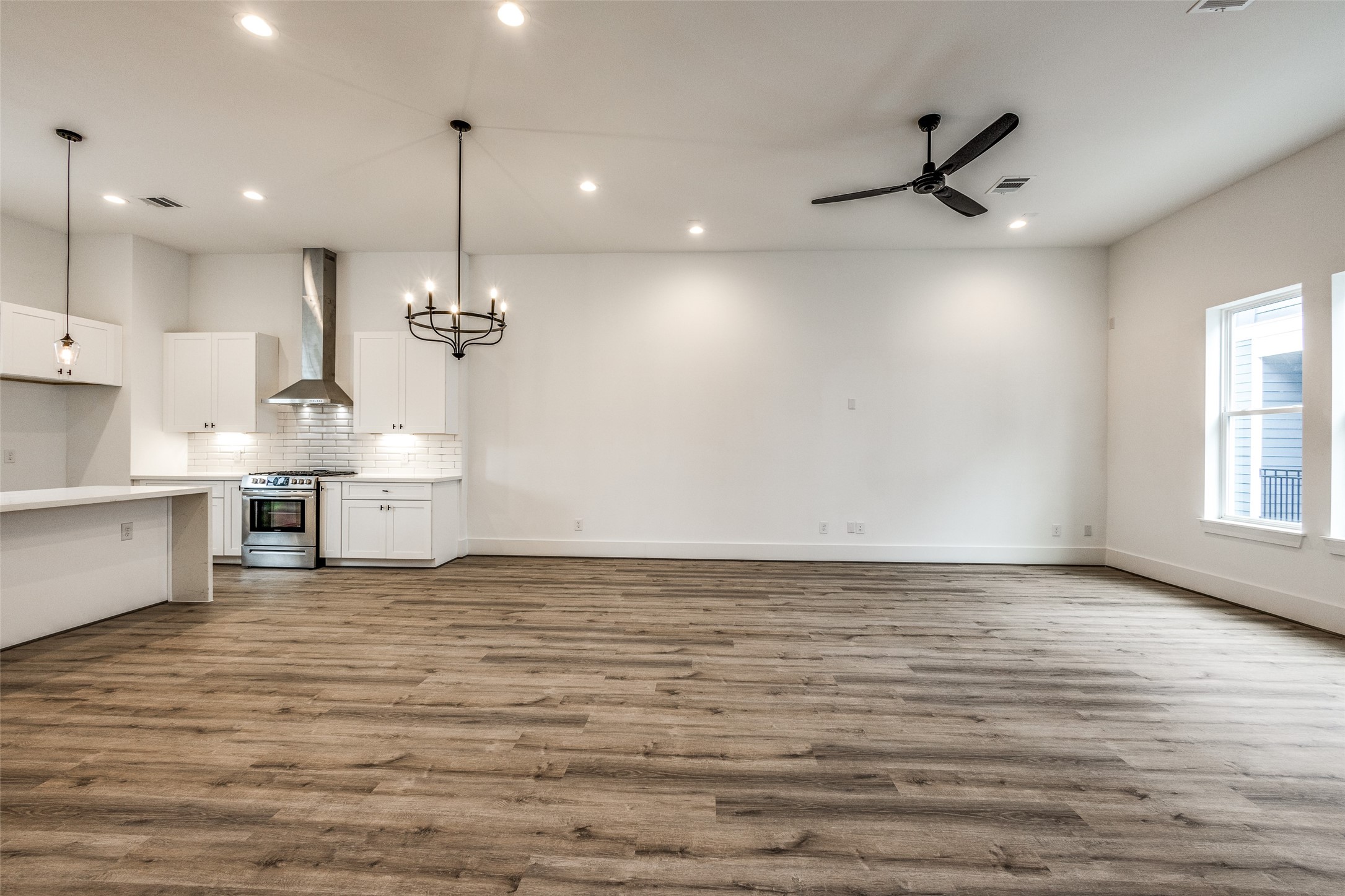 948 Fisher Street, Unit B Houston, TX 77018 - Photo 5 of 25 a view of a kitchen with a stove and a ceiling fan