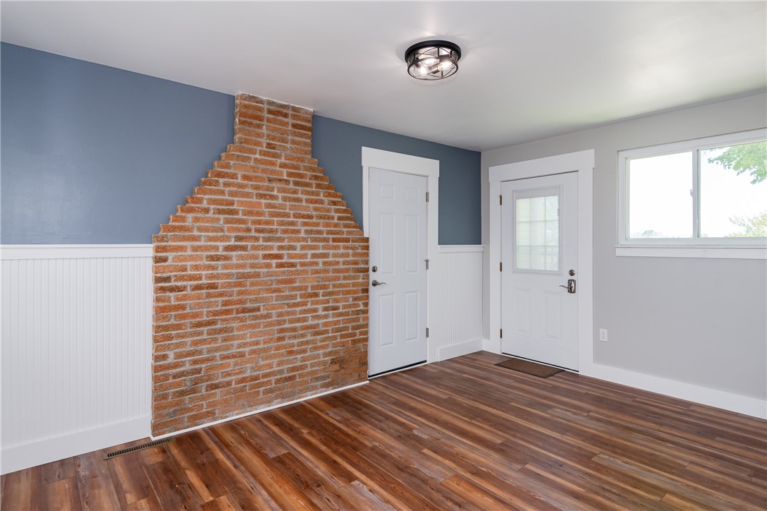 1217 Jasper Road Xenia, OH 45385 - Photo 27 of 62 This versatile room features warm flooring and a distinctive brick accent wall, perfect for any use.