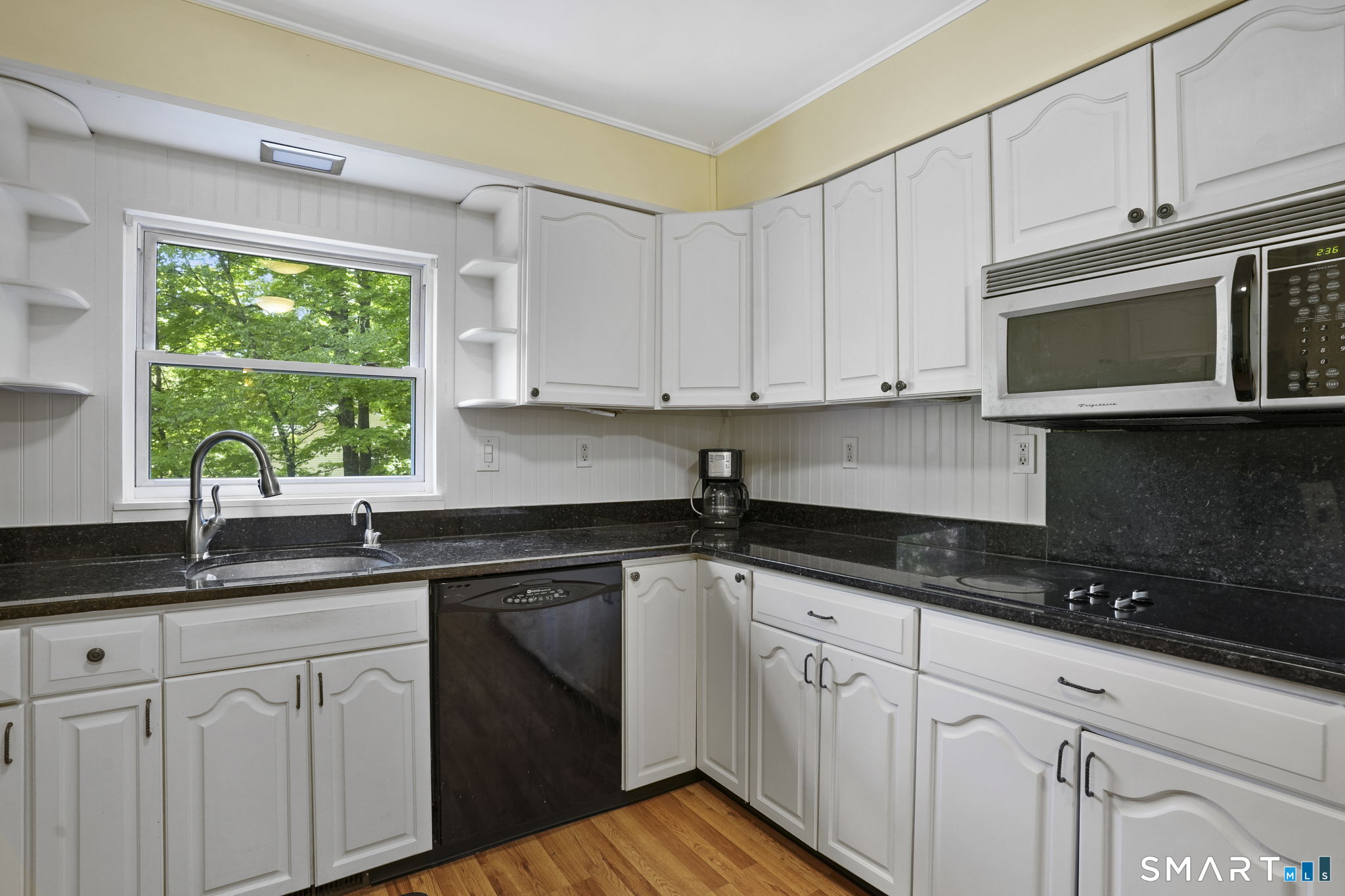 2 Laurel Hill Road South Sherman, CT 06784 - Photo 13 of 35 a kitchen with granite countertop white cabinets sink and window