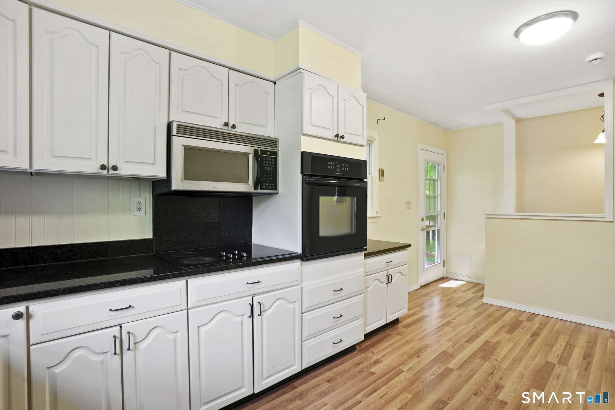 2 Laurel Hill Road South Sherman, CT 06784 - Photo 15 of 35 a kitchen with granite countertop white cabinets and stainless steel appliances